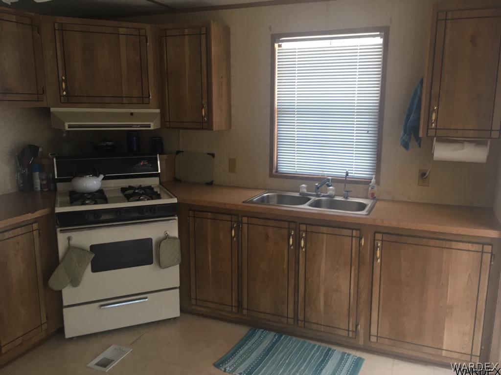 1652 Gran Circulo Fort Mohave, AZ 86426 - Photo 15 of 15 a kitchen with granite countertop a stove and a sink