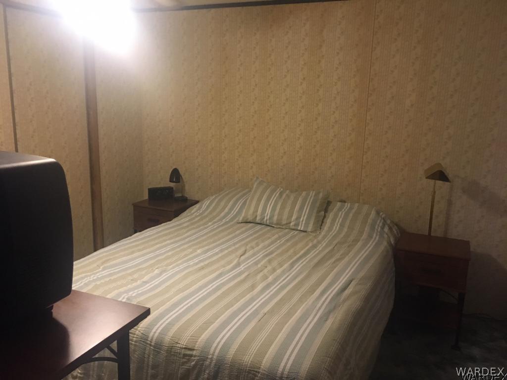 1652 Gran Circulo Fort Mohave, AZ 86426 - Photo 4 of 15 a bedroom with a bed and a table