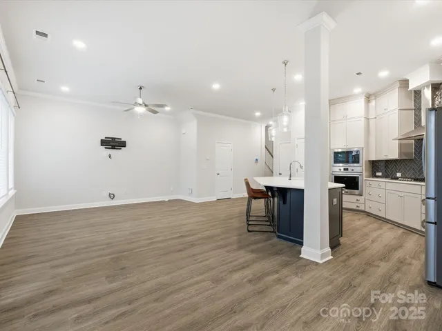 a view of kitchen with refrigerator microwave and stove