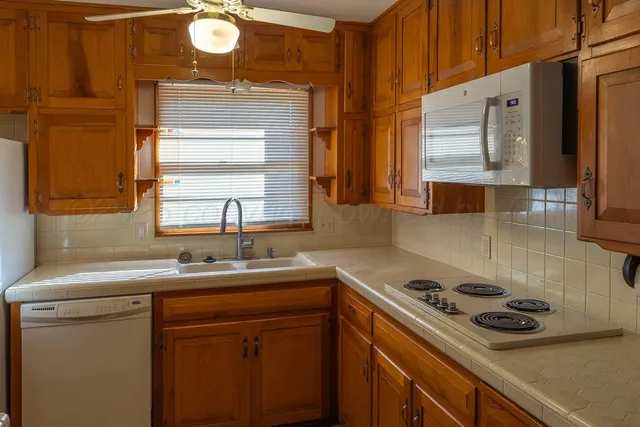 a kitchen with a sink stove and cabinets