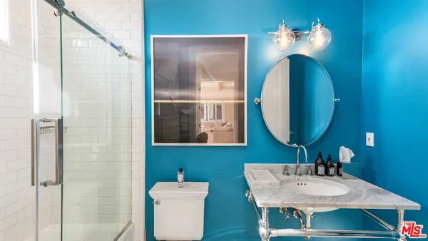 a bathroom with a sink a mirror and a toilet