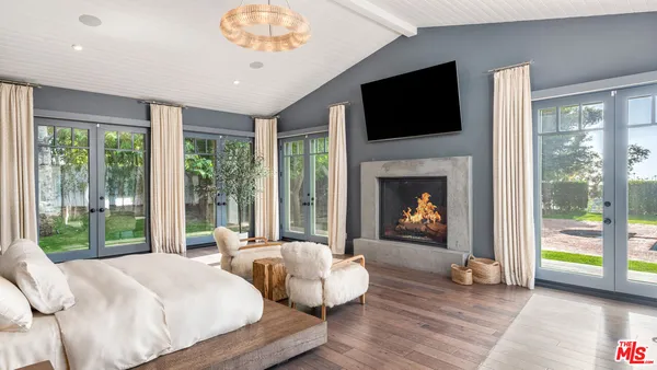 a bedroom with a bed and a fireplace