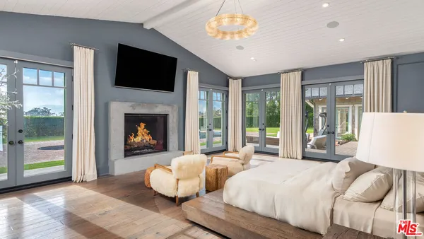 a bedroom with a bed and a large window