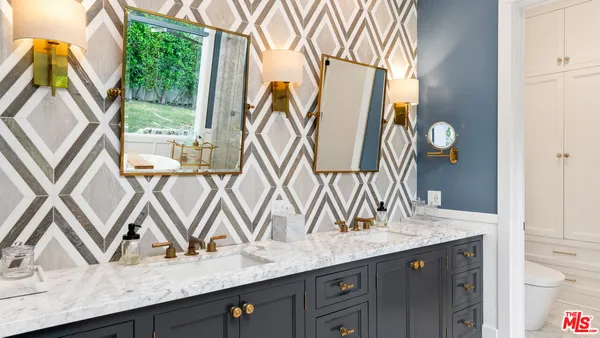 a bathroom with a tub shower vanity and a sink