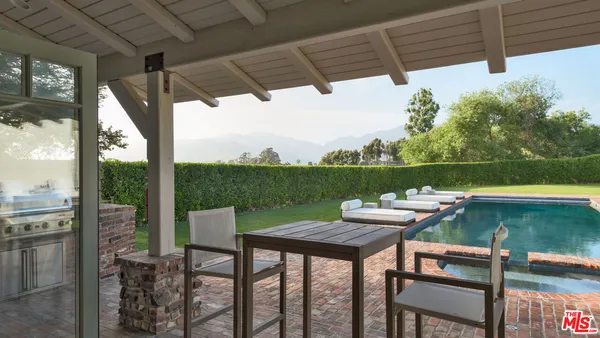 a view of a chairs and fire pit in the patio