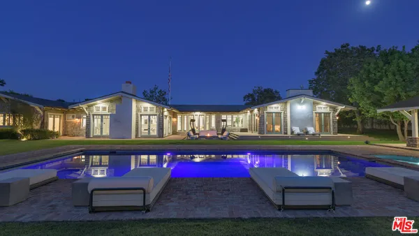 a view of a backyard with sitting area