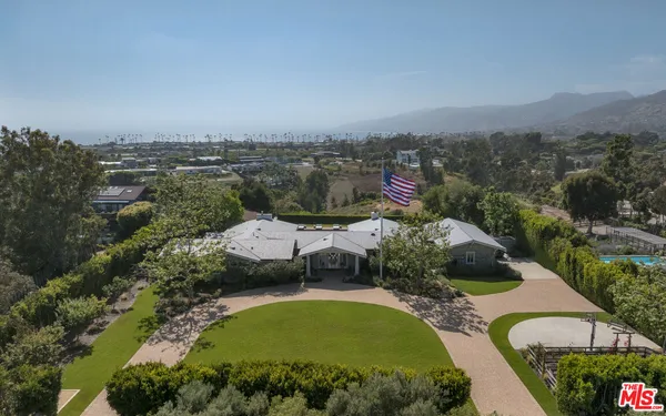 an aerial view of a house with yard swimming pool and outdoor seating