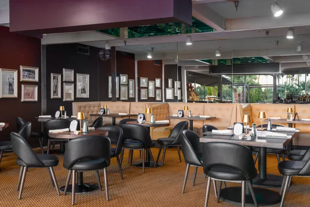 a dining area with a table and chairs