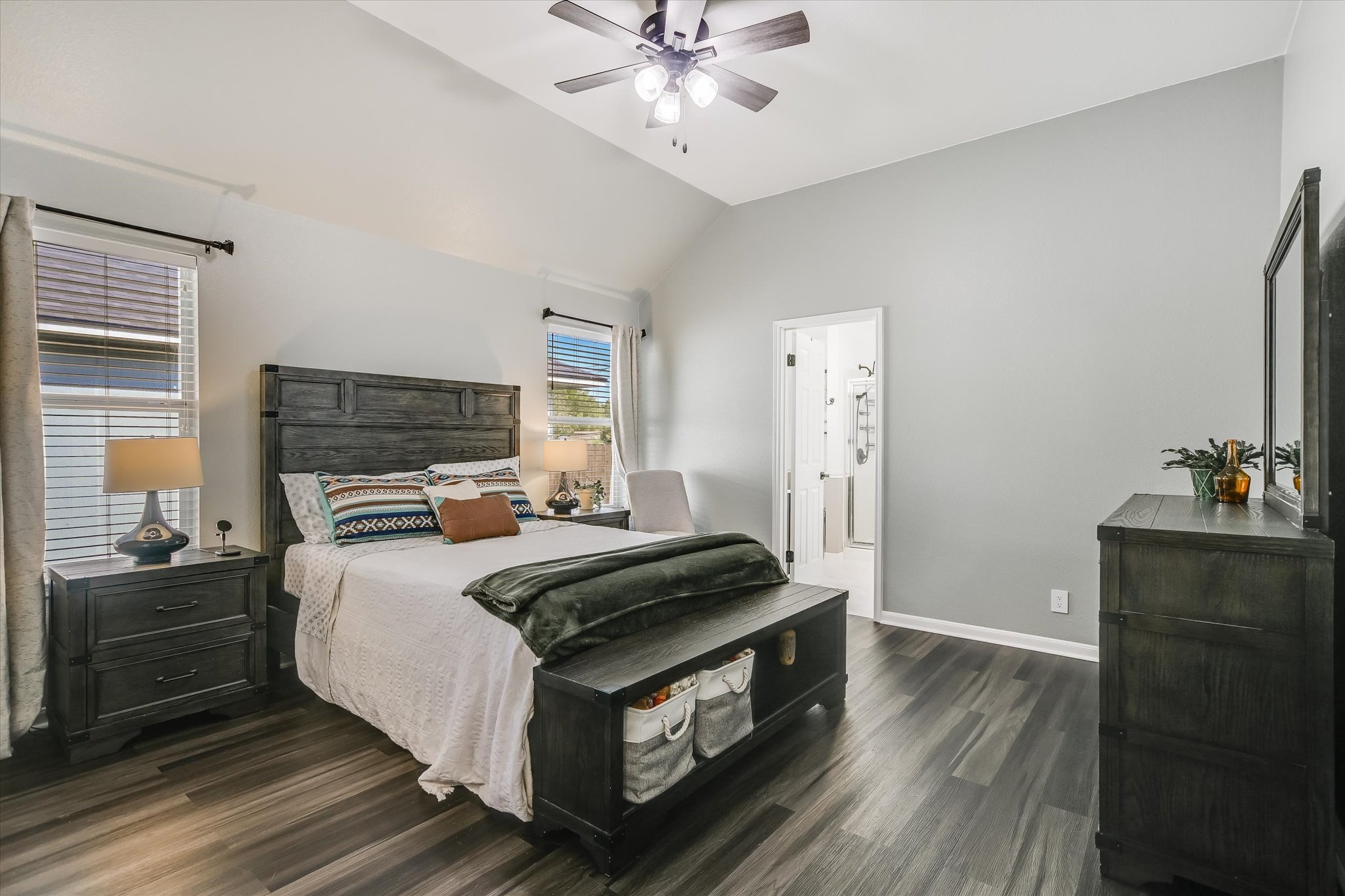 1302 Redbud Lane Leander, TX 78641 - Photo 10 of 28 soothing color in primary bedroom with ceiling fan and laminate floors