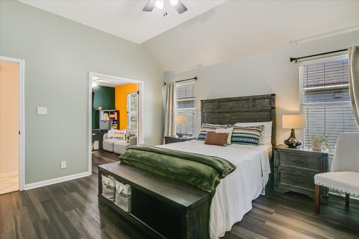 1302 Redbud Lane Leander, TX 78641 - Photo 14 of 28 a bedroom with a bed and a table