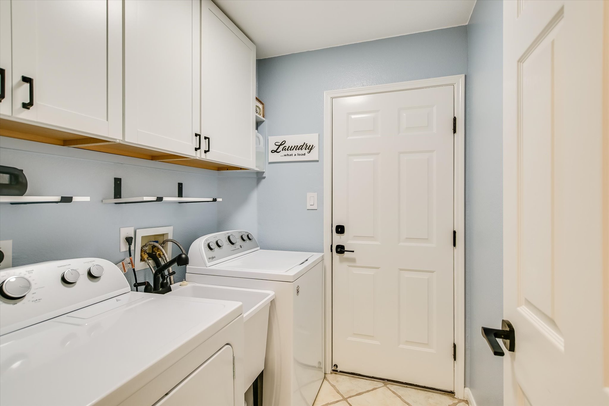 1302 Redbud Lane Leander, TX 78641 - Photo 22 of 28 nice laundry sink between the washer & dryer, will spacious cabinets for storage