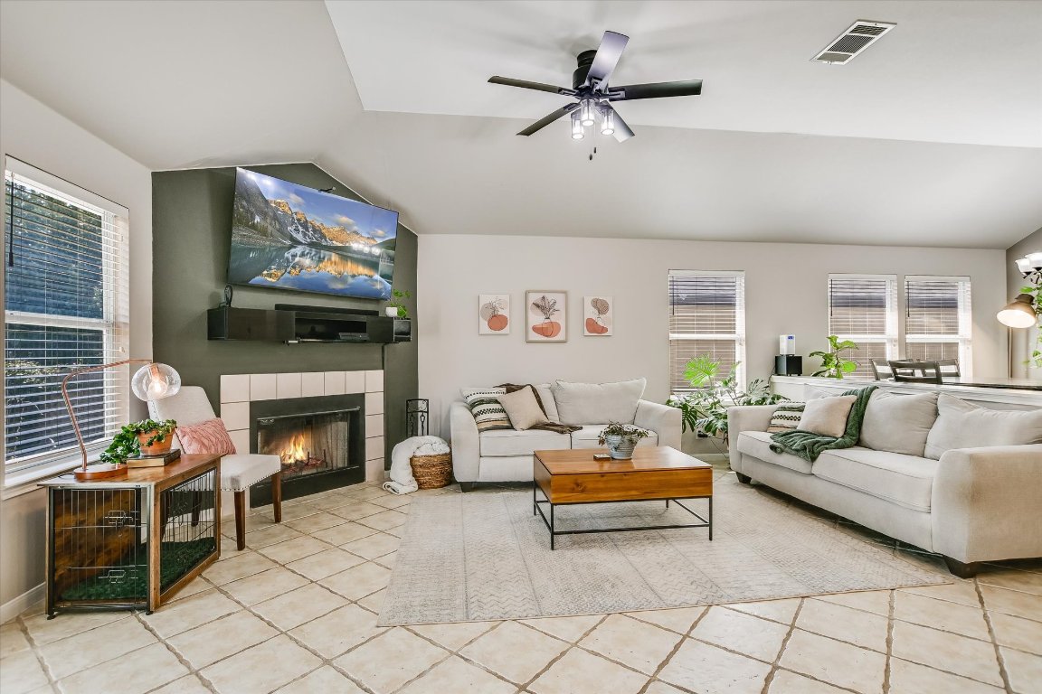 1302 Redbud Lane Leander, TX 78641 - Photo 3 of 28 a living room with furniture a flat screen tv and a fireplace