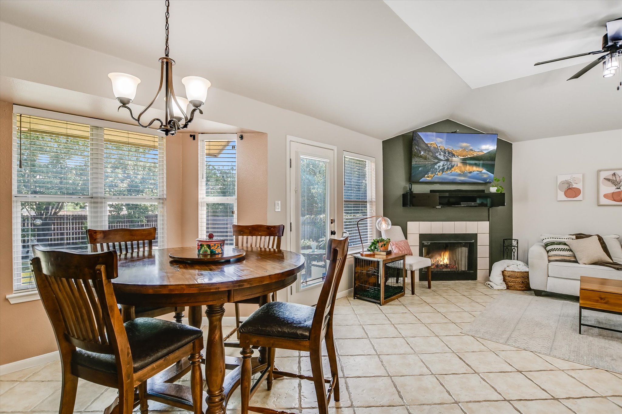 1302 Redbud Lane Leander, TX 78641 - Photo 8 of 28 a dining room with furniture a fireplace and large windows