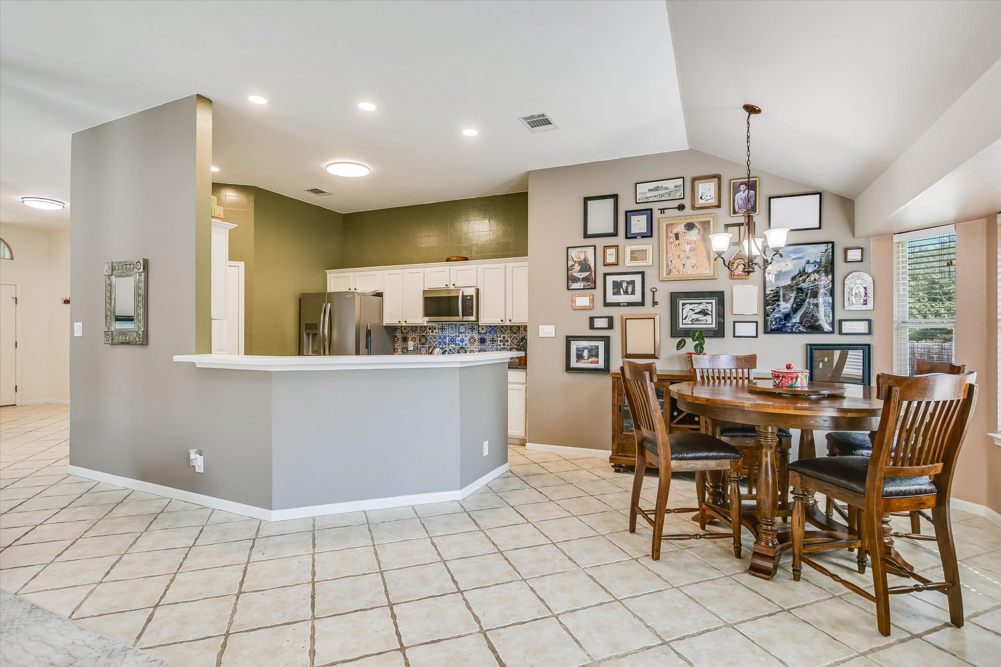 1302 Redbud Lane Leander, TX 78641 - Photo 9 of 28 a living room with kitchen island furniture and a chandelier