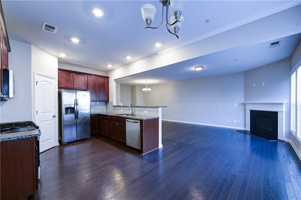 1226 Fischer Trace Cumming, GA 30041 - Photo 6 of 24 a large kitchen with a wooden floor and a refrigerator