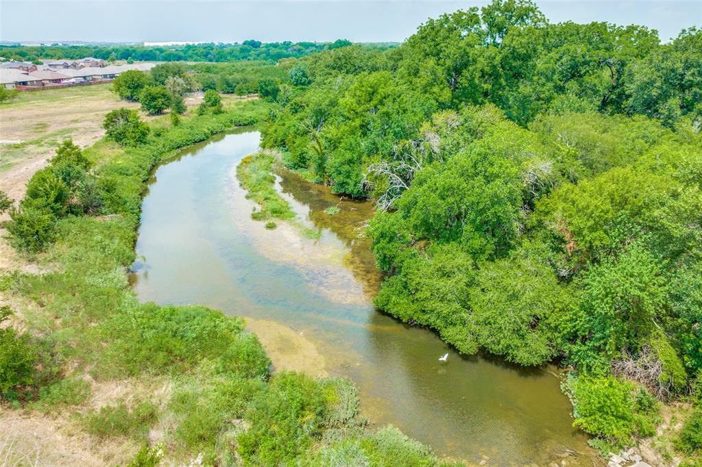 14599 Ridgetop Road Fort Worth, TX 76262 - Photo 3 of 5 a view of a lake with a yard and mountain view