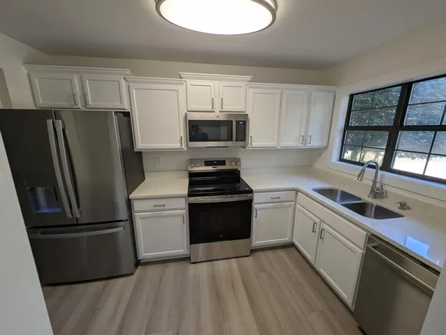 a kitchen with cabinets and appliances