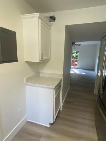 a view of empty room with wooden floor