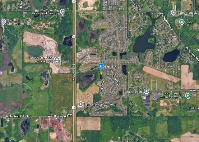 an aerial view of residential houses with outdoor space and street view