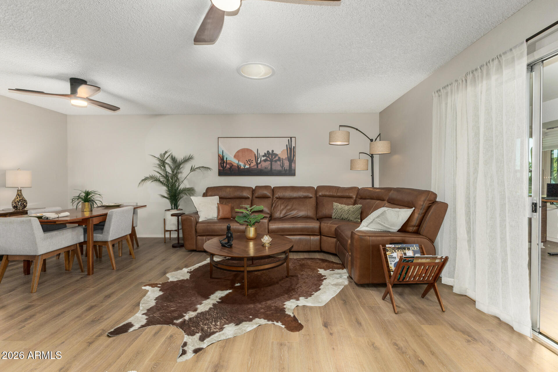 9933 West Mountain View Road Sun City, AZ 85351 - Photo 12 of 24 a living room with furniture wooden floor and a window