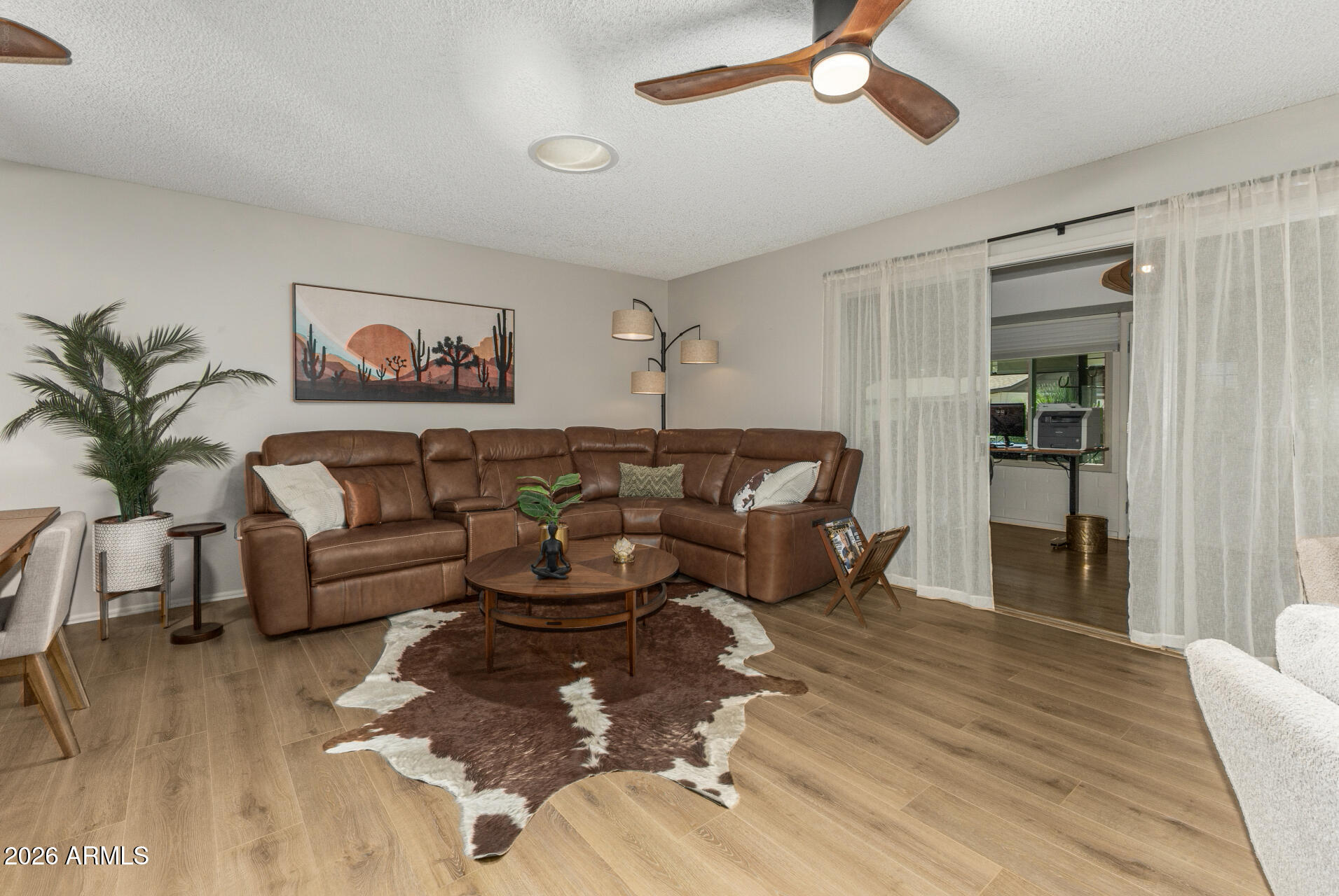 9933 West Mountain View Road Sun City, AZ 85351 - Photo 13 of 24 a living room with furniture and a large window