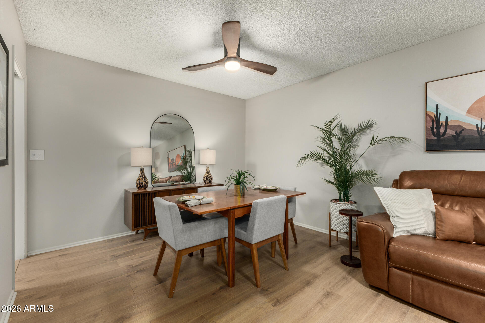 9933 West Mountain View Road Sun City, AZ 85351 - Photo 14 of 24 a view of a workspace room with furniture and wooden floor