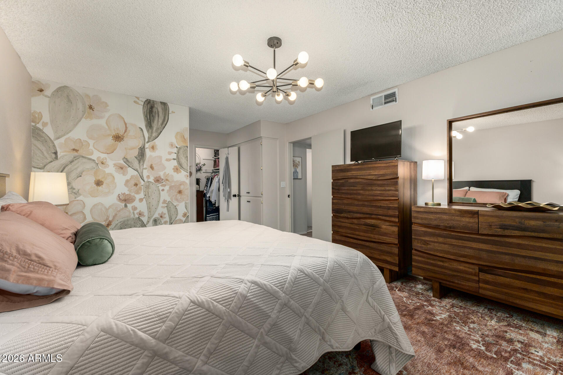 9933 West Mountain View Road Sun City, AZ 85351 - Photo 19 of 24 a bedroom with a bed and a flat screen tv