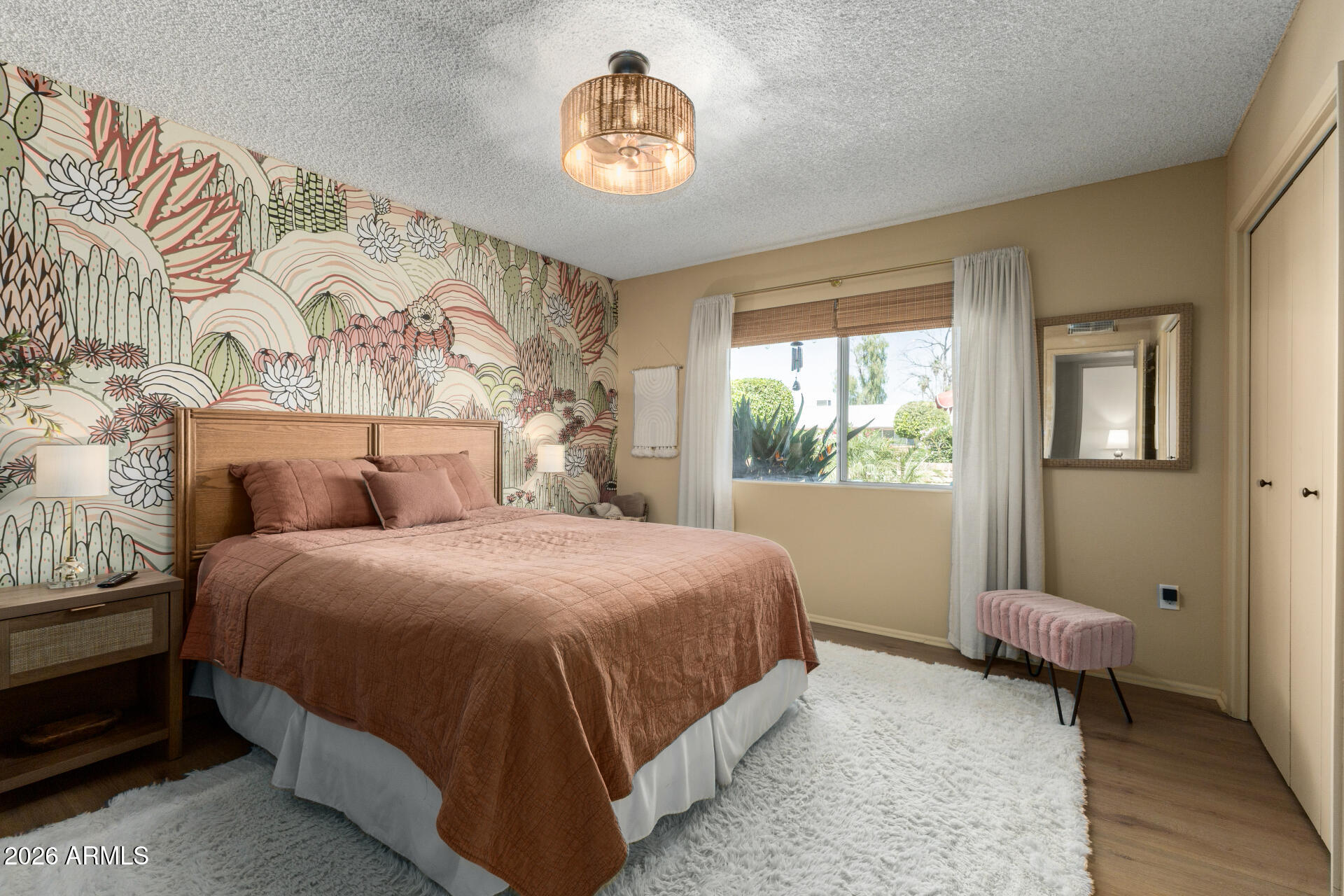 9933 West Mountain View Road Sun City, AZ 85351 - Photo 20 of 24 a bedroom with a bed and a window