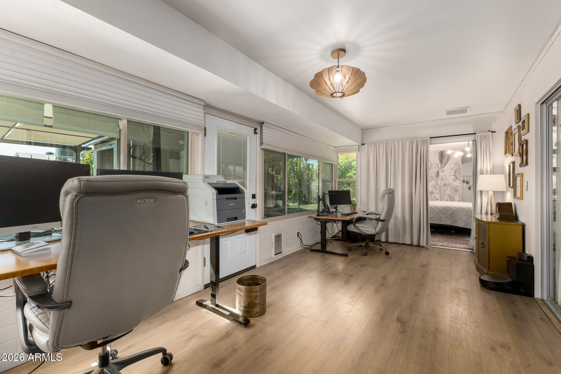 9933 West Mountain View Road Sun City, AZ 85351 - Photo 22 of 24 a work room with furniture and a chandelier