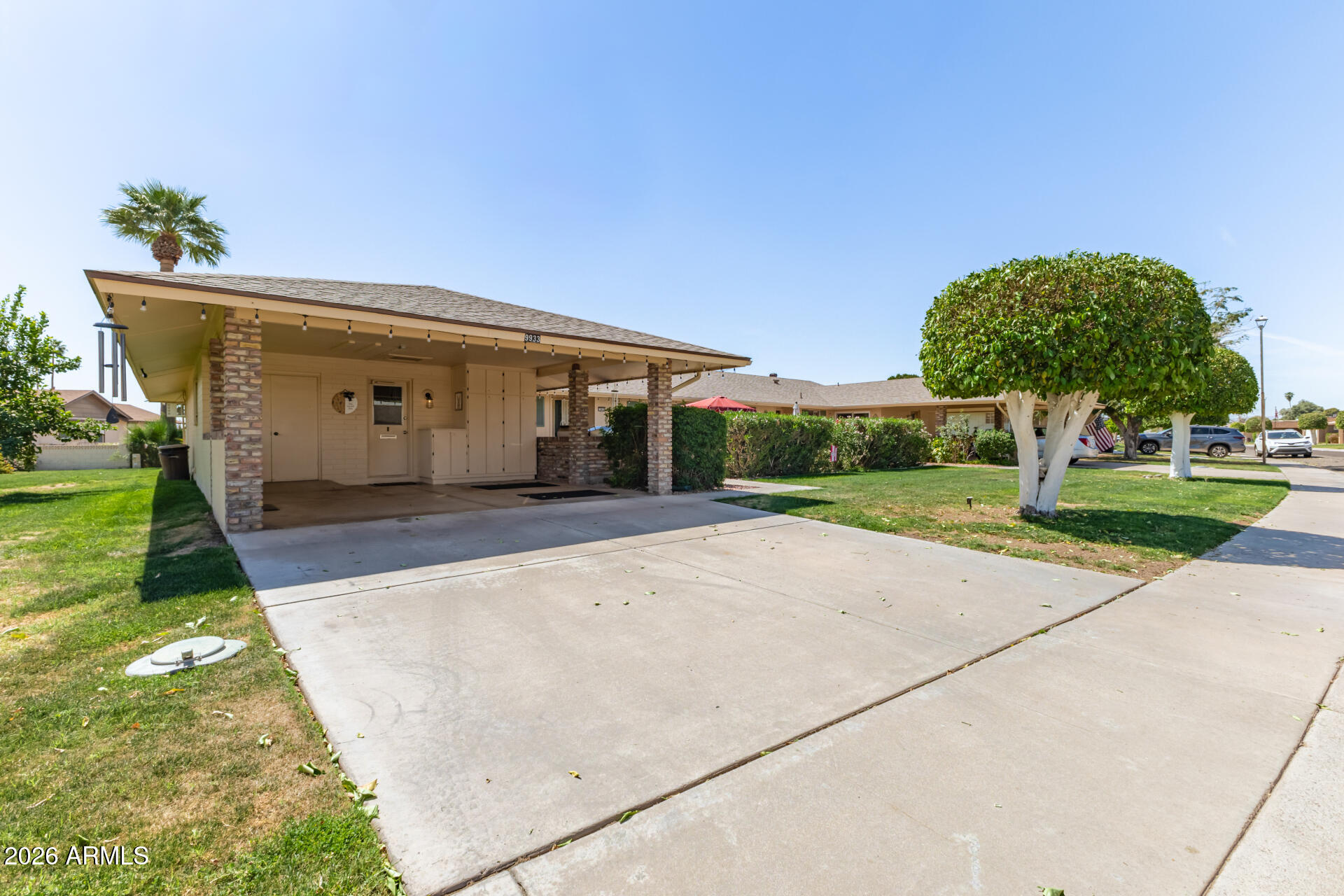 9933 West Mountain View Road Sun City, AZ 85351 - Photo 2 of 24 a front view of house with yard