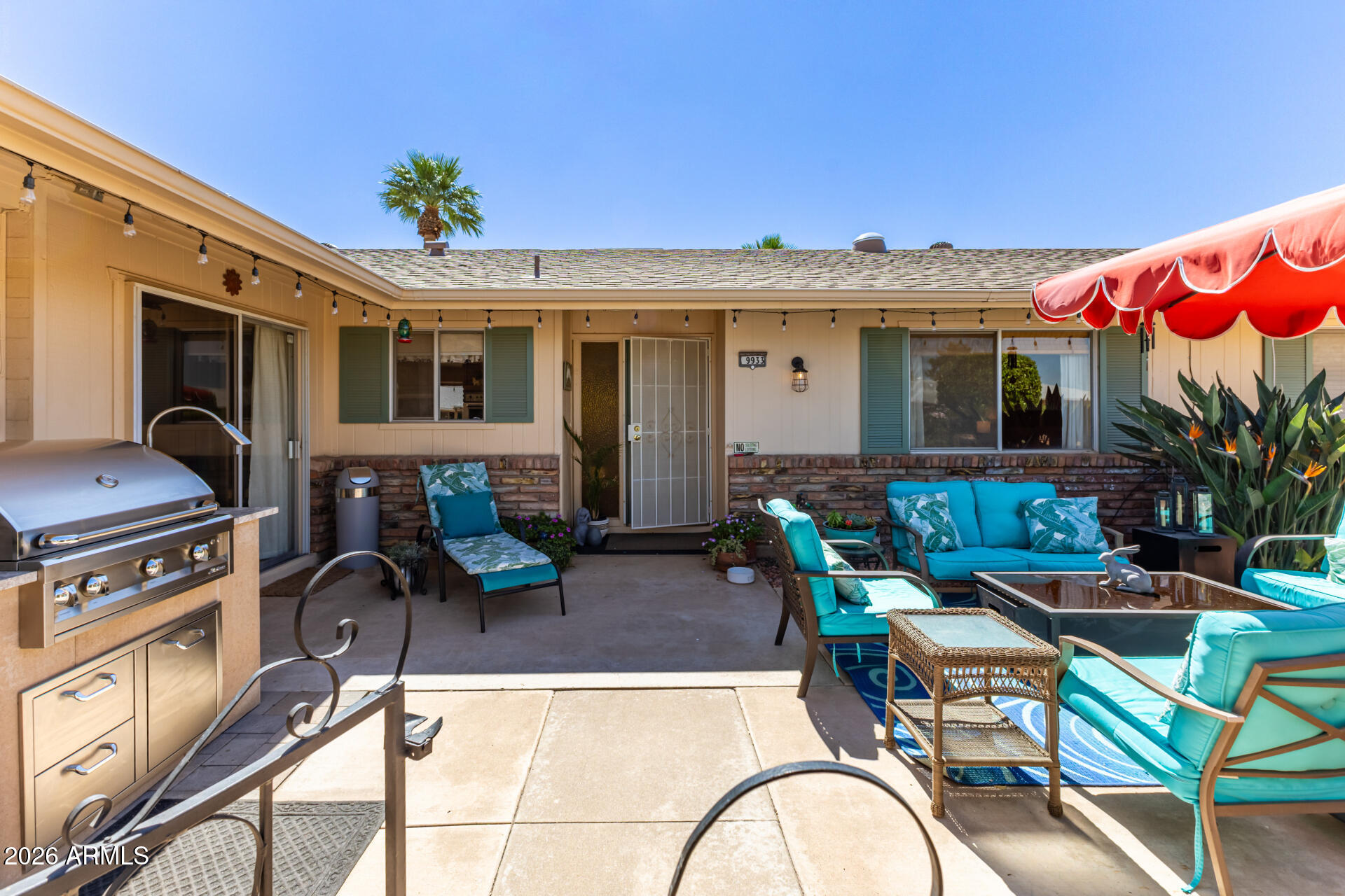 9933 West Mountain View Road Sun City, AZ 85351 - Photo 6 of 24 a view of a patio with couches chairs and potted plants