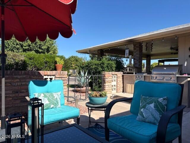 9933 West Mountain View Road Sun City, AZ 85351 - Photo 8 of 24 a outdoor living space with furniture and plants