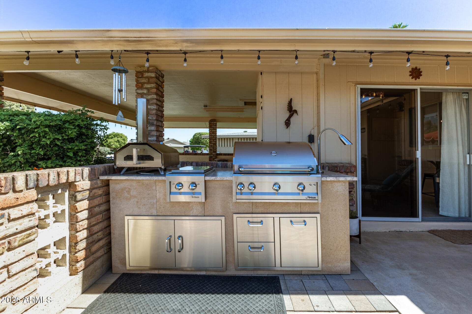 9933 West Mountain View Road Sun City, AZ 85351 - Photo 9 of 24 a kitchen with a stove and a refrigerator