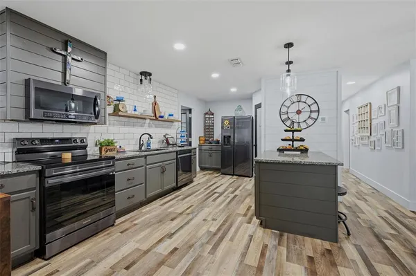 a kitchen with granite countertop a stove and a sink