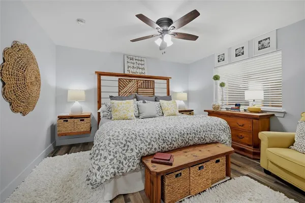 a bedroom with furniture and a large window