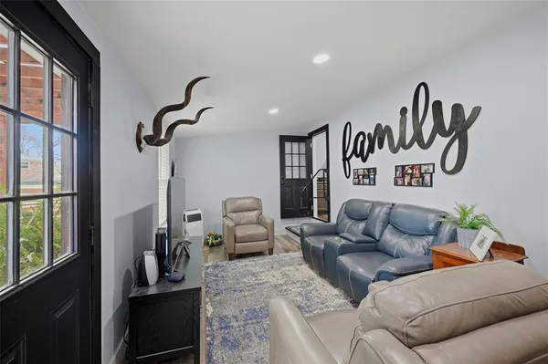 a living room with furniture or couch and a floor to ceiling window