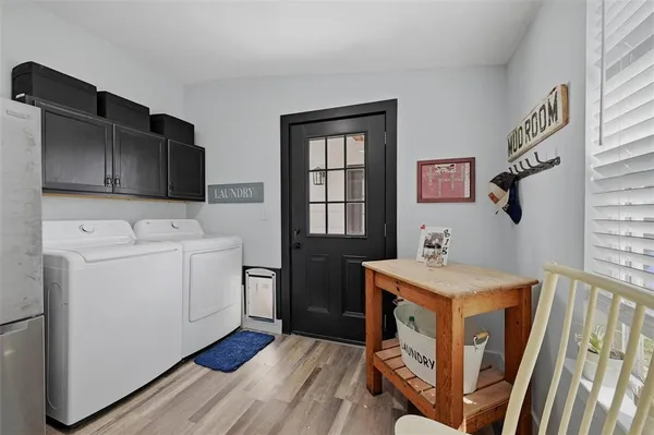 a utility room with cabinets washer and dryer