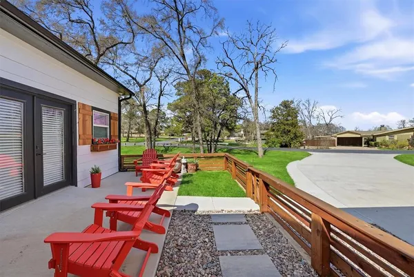 a backyard of a house with outdoor seating
