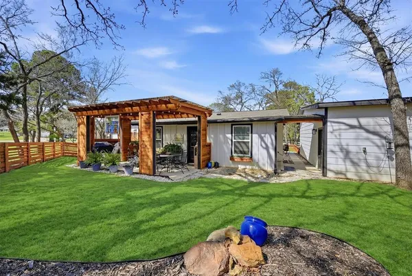 a view of a house with a backyard porch and sitting area