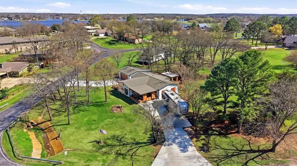 an aerial view of a house with a yard