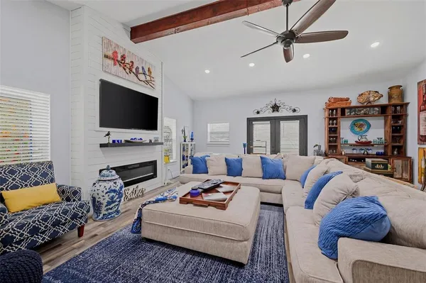 a living room with furniture and a flat screen tv