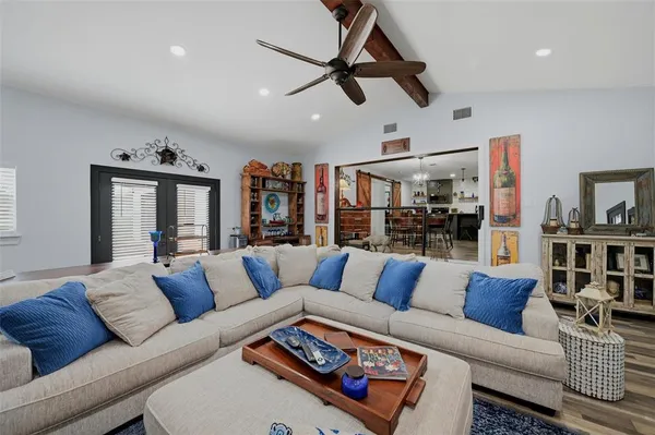 a living room with furniture ceiling fan and a rug