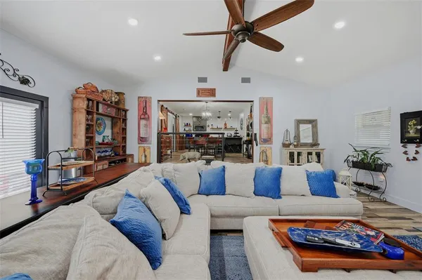 a living room with furniture and kitchen view