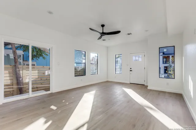 an empty room with windows and closet