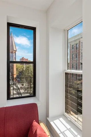 a living room with furniture a window and gym equipment
