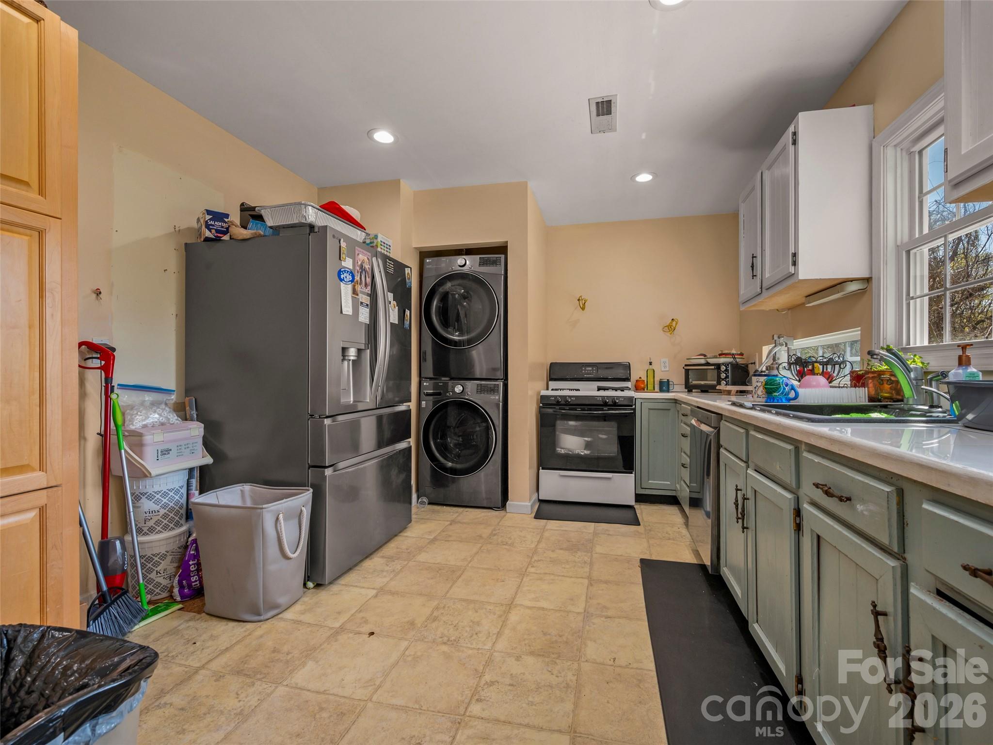 120 East Howard Street Tryon, NC 28782 - Photo 15 of 31 a kitchen with stainless steel appliances a refrigerator and a stove