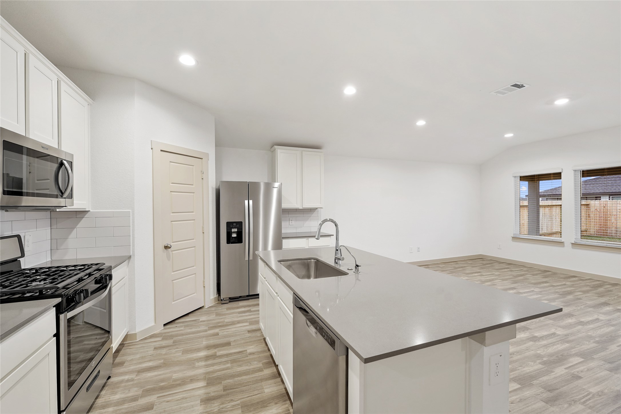714 Boer Plains Drive Rosharon, TX 77583 - Photo 7 of 11 a kitchen that has a sink cabinets counter space and stainless steel appliances