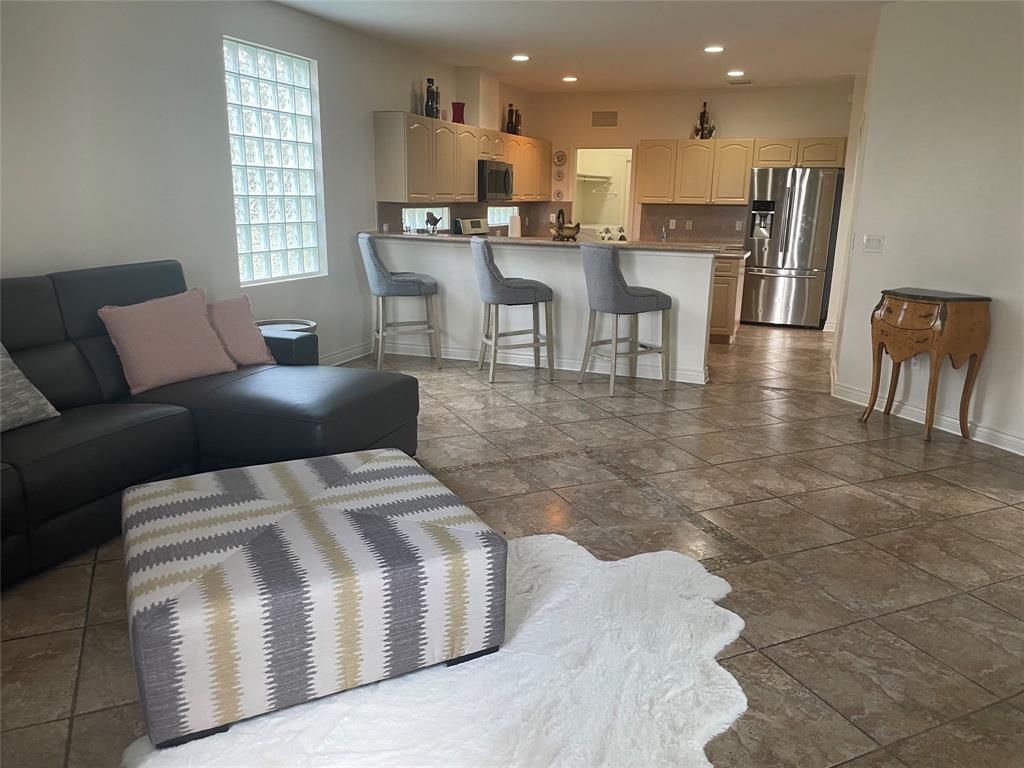 10690 OldHammock Way Wellington, FL 33414 - Photo 5 of 9 a living room with stainless steel appliances kitchen island granite countertop a table chairs and a view of living room