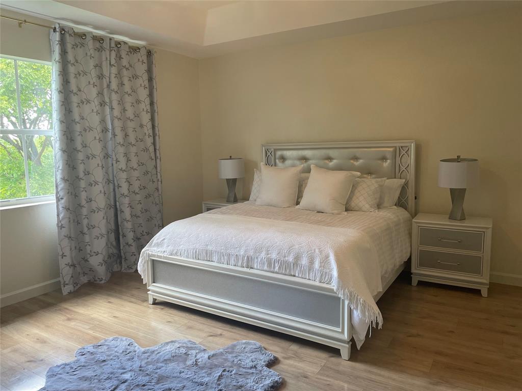 10690 OldHammock Way Wellington, FL 33414 - Photo 7 of 9 a bedroom with a bed and a window