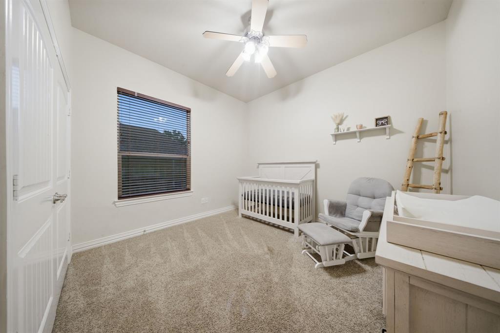 603 Cedar Drive Pilot Point, TX 76258 - Photo 27 of 39 Carpeted room featuring a single window with blinds, a ceiling fan with integrated lighting, and a white paneled door